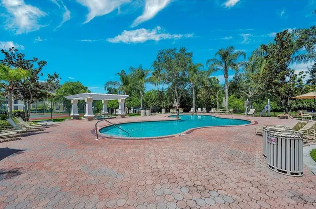 a view of a house with backyard and swimming pool
