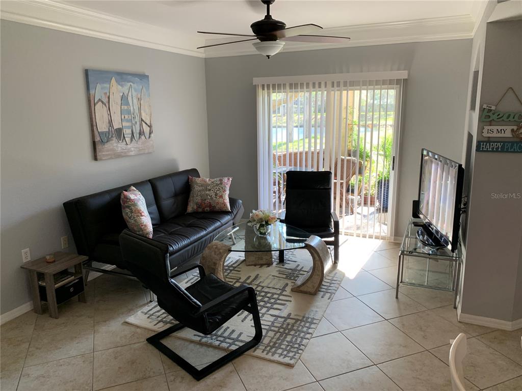 5134 Northridge Road, Unit 112 Sarasota, FL 34238 - Photo 6 of 15 a living room with furniture a fireplace and a flat screen tv