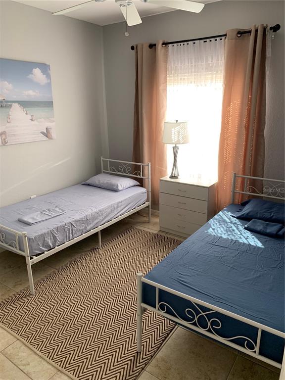 5134 Northridge Road, Unit 112 Sarasota, FL 34238 - Photo 7 of 15 a bed sitting in a bedroom next to a window