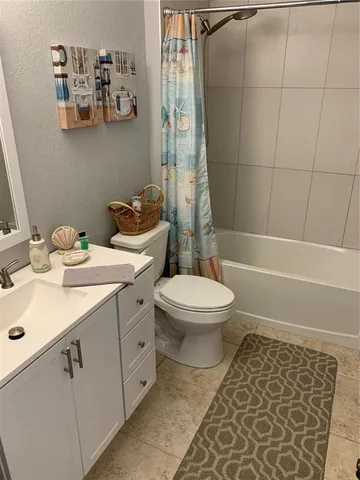 a bathroom with a toilet a sink and shower