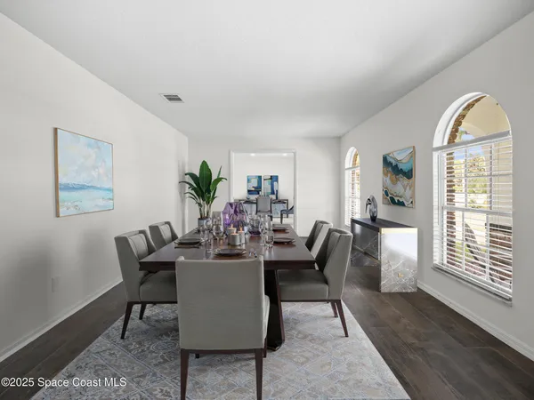 an empty room with wooden floor windows and outdoor view