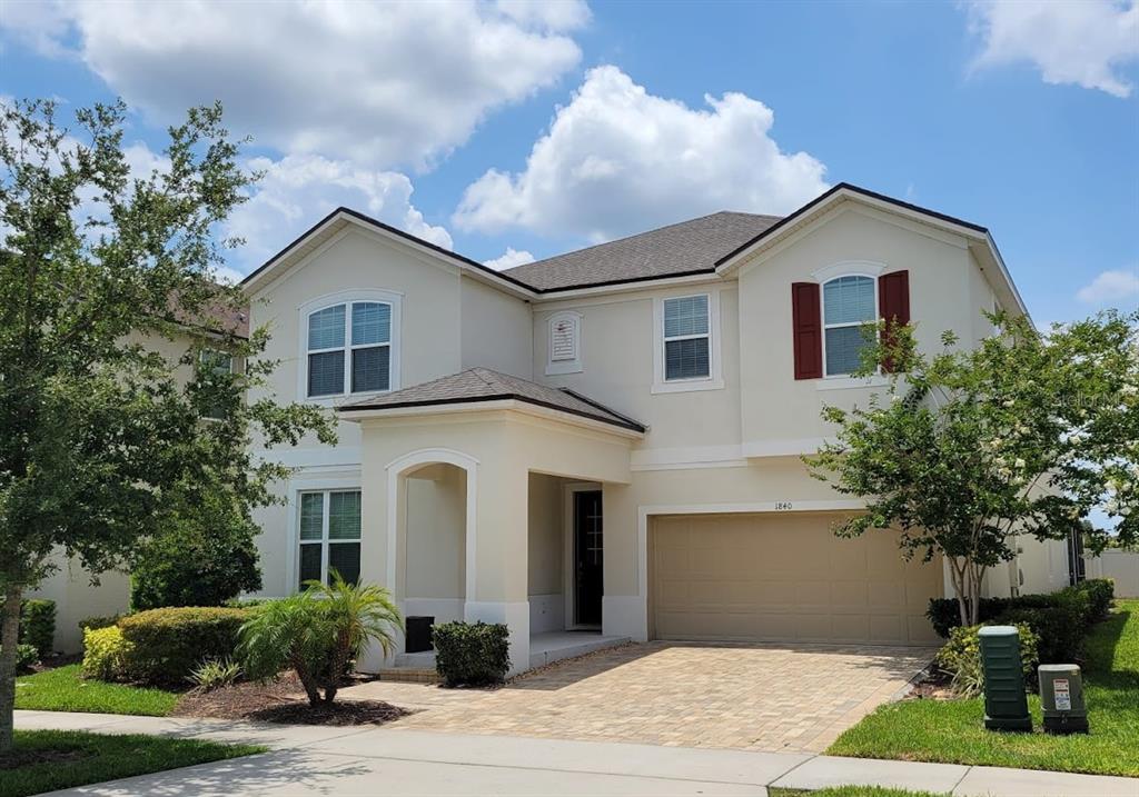 1840 Caribbean View Terrace Kissimmee, FL 34747 - Photo 1 of 56 a front view of a house with a yard and potted plants