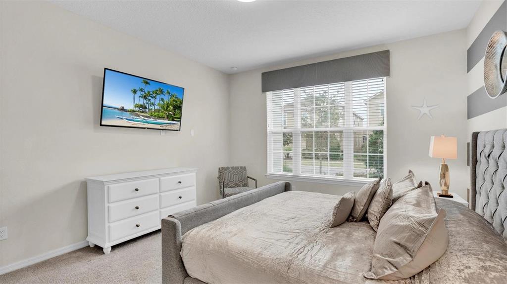 1840 Caribbean View Terrace Kissimmee, FL 34747 - Photo 13 of 56 a bedroom with a bed and a large window