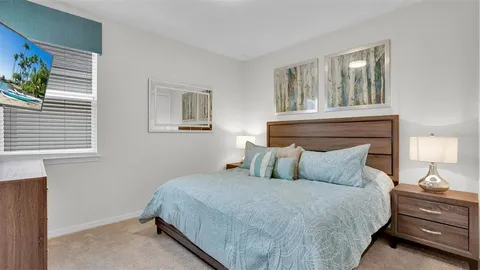 a bedroom that has a bed and a chair in it