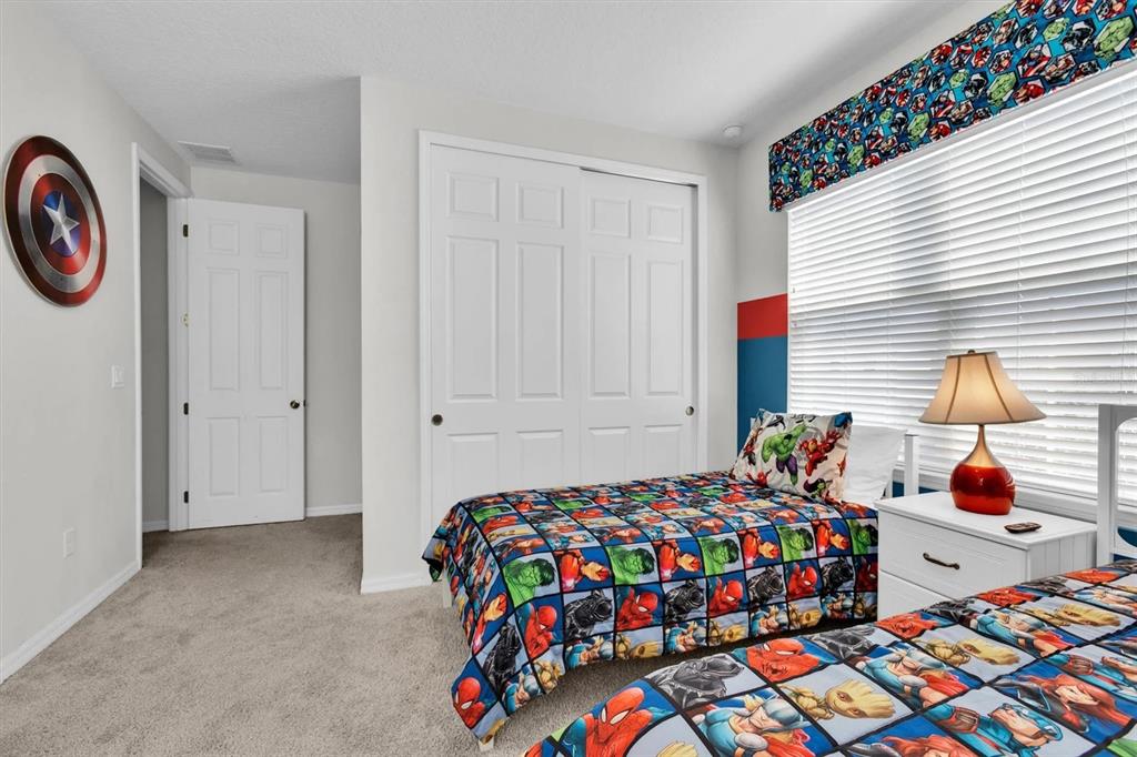 1840 Caribbean View Terrace Kissimmee, FL 34747 - Photo 20 of 56 a bedroom that has a bed and a chair in it