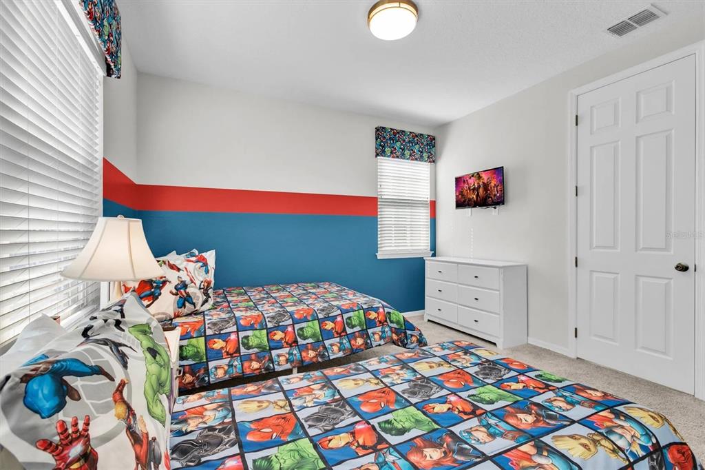 1840 Caribbean View Terrace Kissimmee, FL 34747 - Photo 22 of 56 a bedroom with a bed and a dresser in it