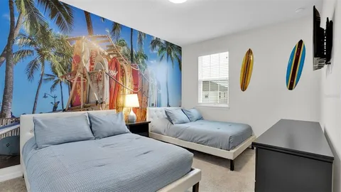 a bedroom with a bed and a chandelier