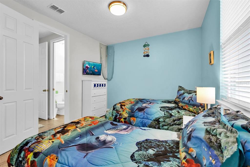 1840 Caribbean View Terrace Kissimmee, FL 34747 - Photo 34 of 56 a bedroom with bed and a window