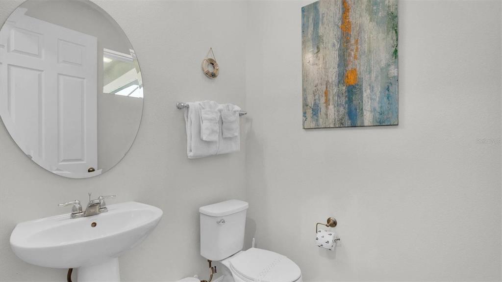 1840 Caribbean View Terrace Kissimmee, FL 34747 - Photo 8 of 56 a bathroom with a toilet sink and mirror