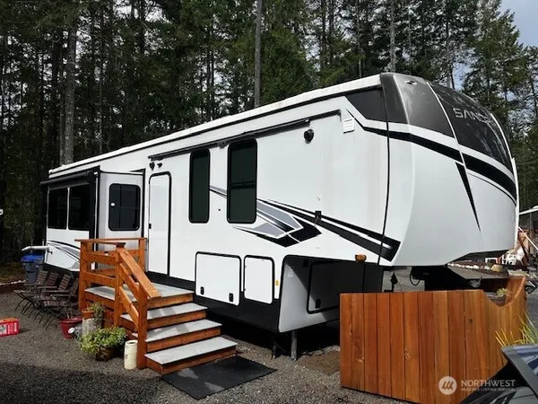 a backyard of a house with wooden floor and outdoor seating