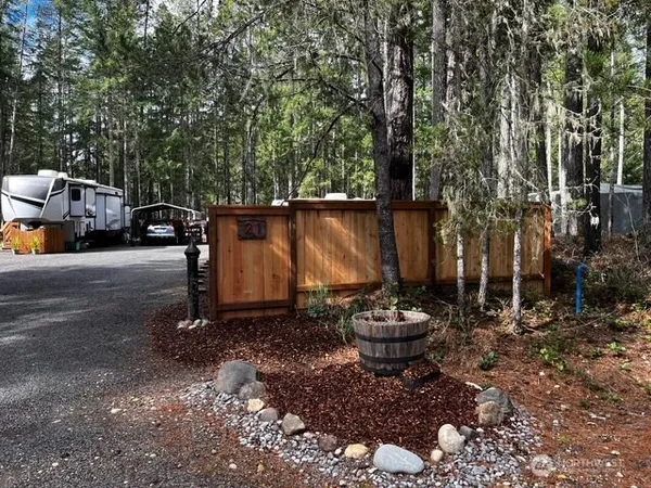 a view of a backyard with table and chairs and potted plants