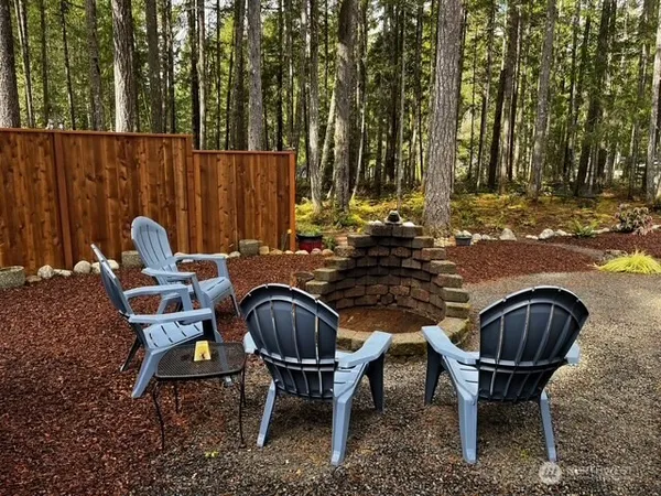 a view of a chairs and table in the backyard