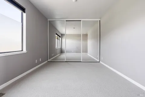 a view of a living room with furniture and flat screen tv