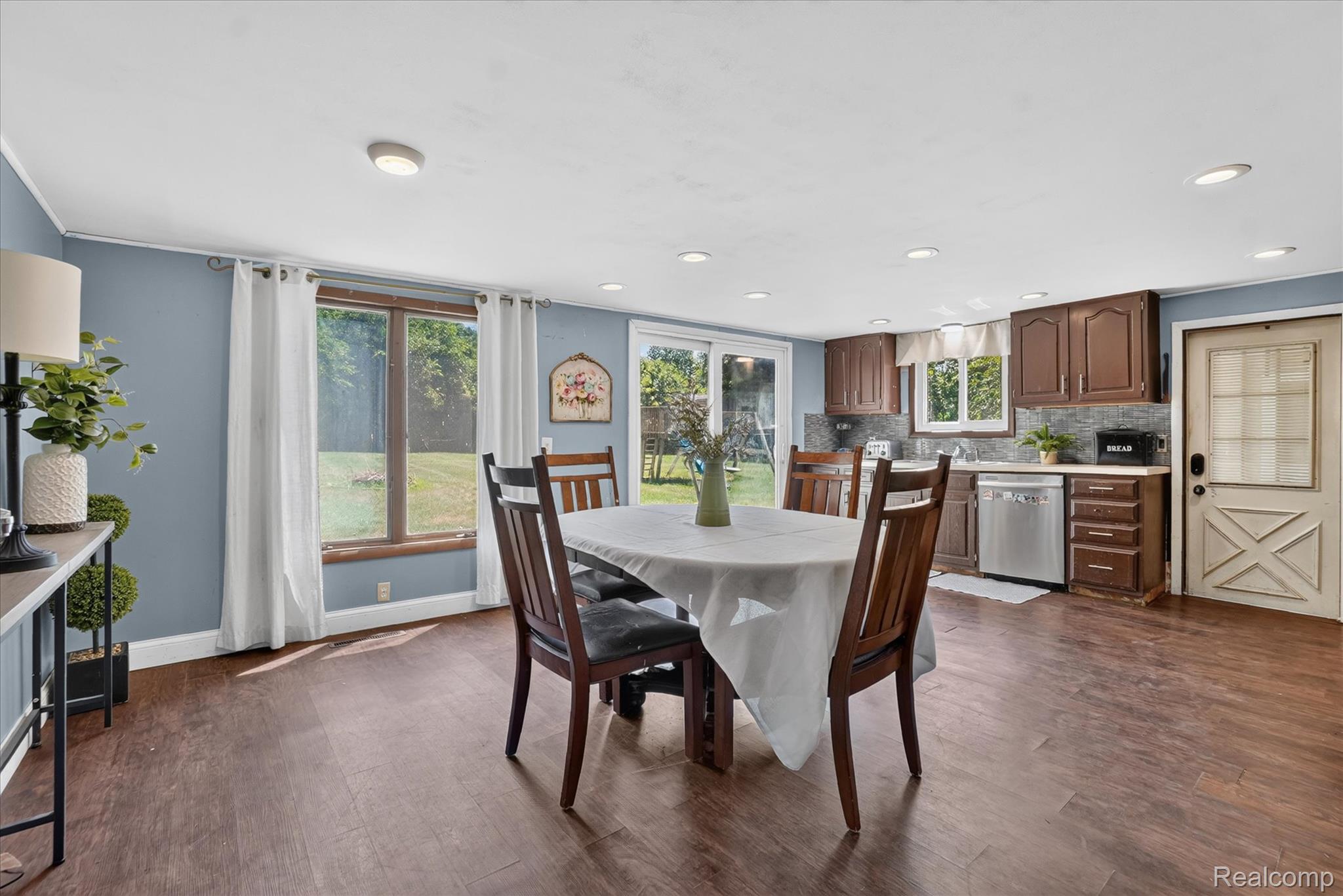508 Deland Road Flushing, MI 48433 - Photo 11 of 38 Open-concept living space featuring wood-finish flooring, recessed lighting, and a kitchen area with stainless steel appliances