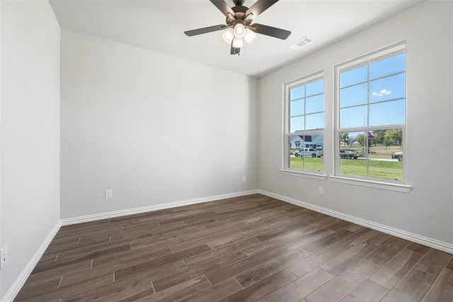 wooden floor in an empty room with a window