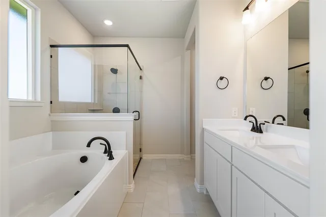 a bathroom with a tub sink a mirror and vanity