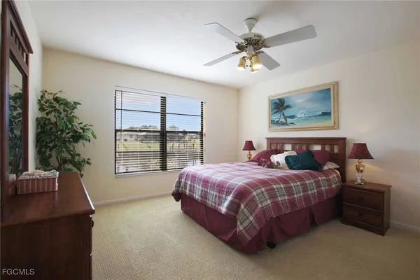 a spacious bedroom with a bed and a chandelier