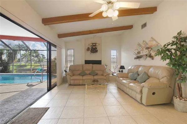 a living room with furniture and a floor to ceiling window