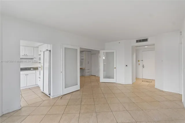 a kitchen with granite countertop white cabinets and a sink