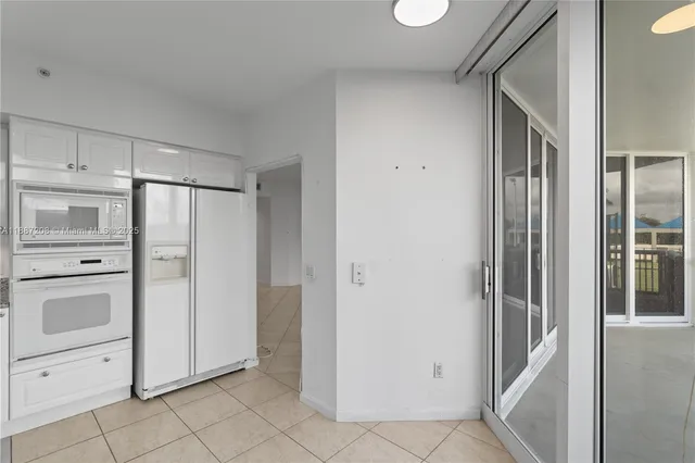 a view of a room with a stylish ceiling fan and entryway