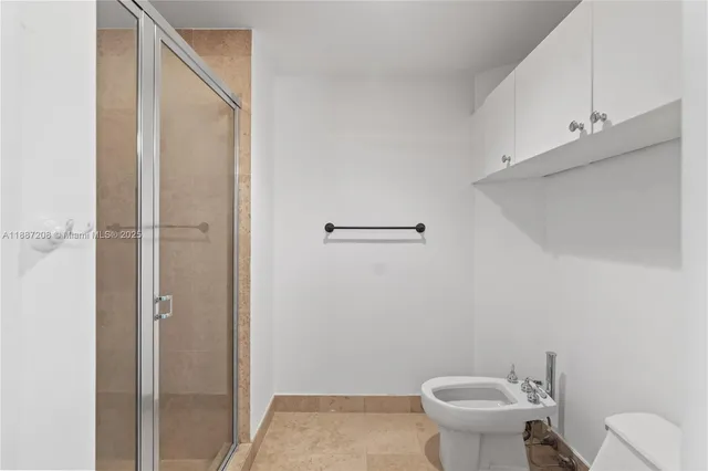 a large bathroom with a sink a large mirror and a toilet