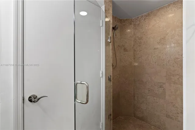 a bathroom with a bathtub a double vanity sink and mirror