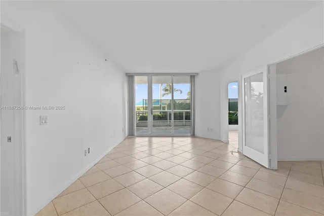 a view of empty room with cabinet and chandelier
