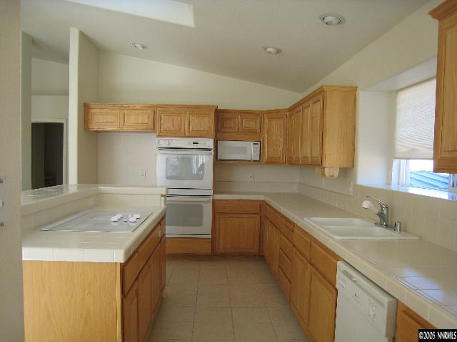 4522 Goodwin Road Sparks, NV 89436 - Photo 2 of 9 a kitchen with a sink stove and cabinets