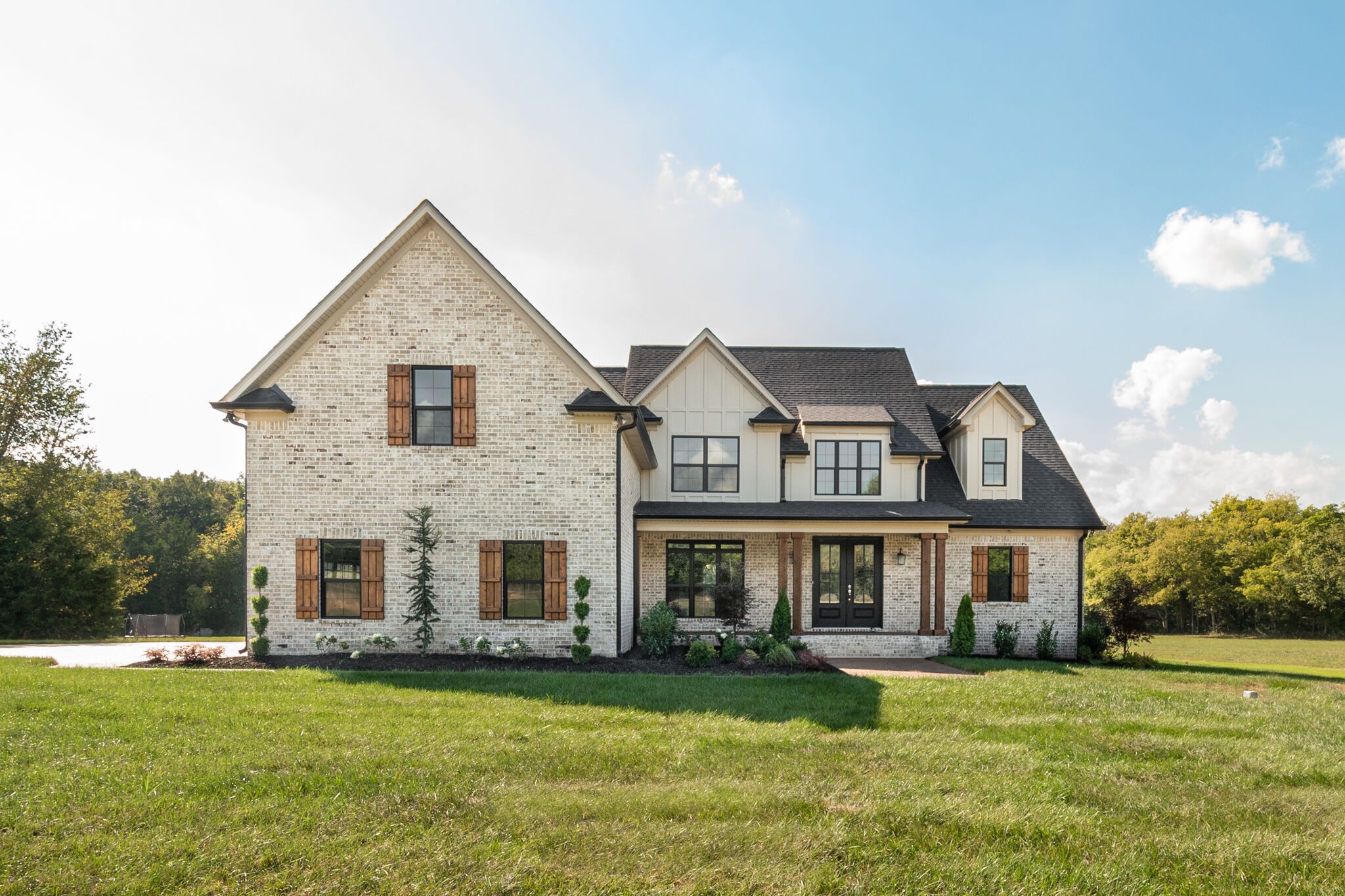12599 North Milton Road Milton, TN 37118 - Photo 1 of 34 a front view of a house with a garden
