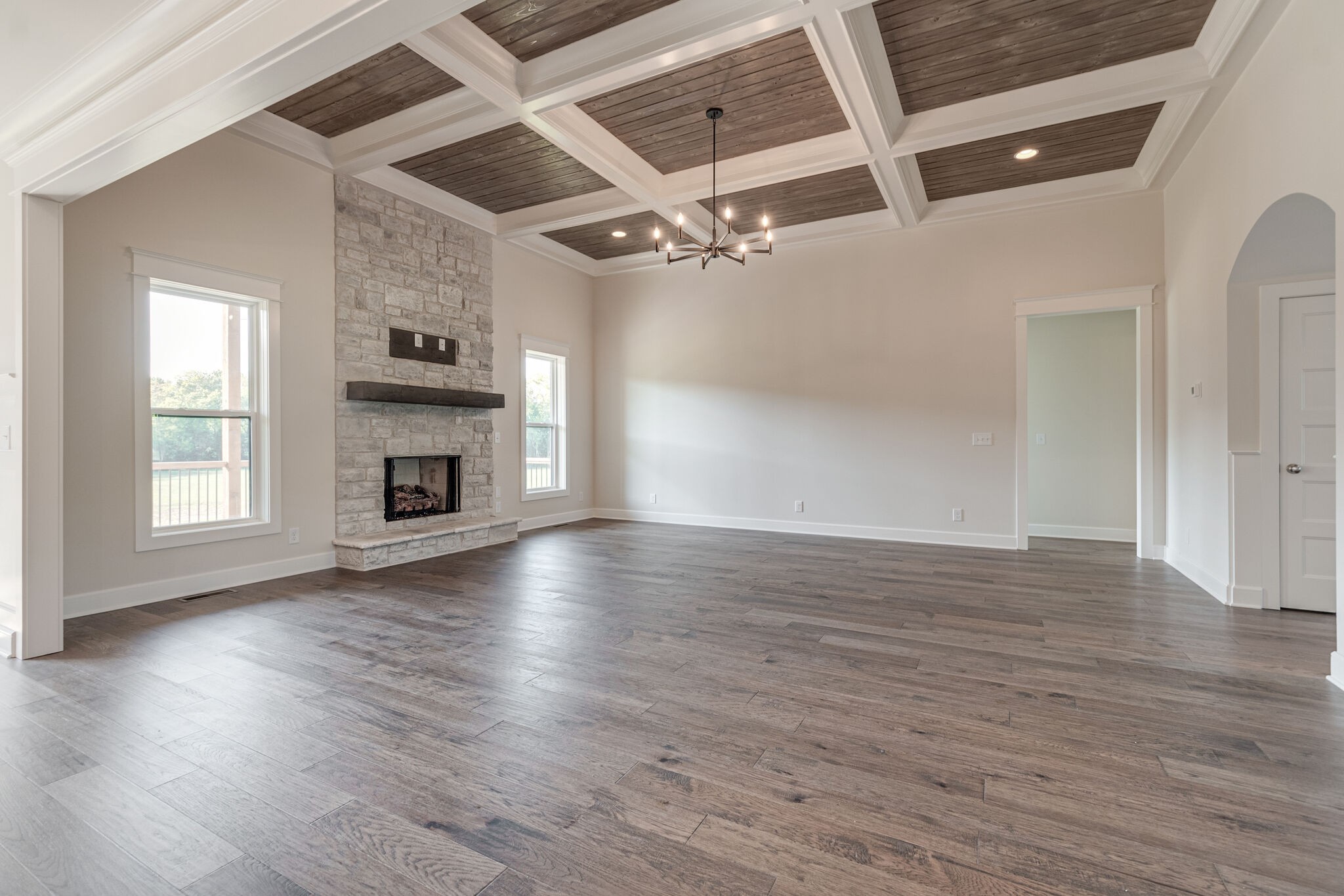 12599 North Milton Road Milton, TN 37118 - Photo 11 of 34 an empty room with wooden floor fireplace and windows