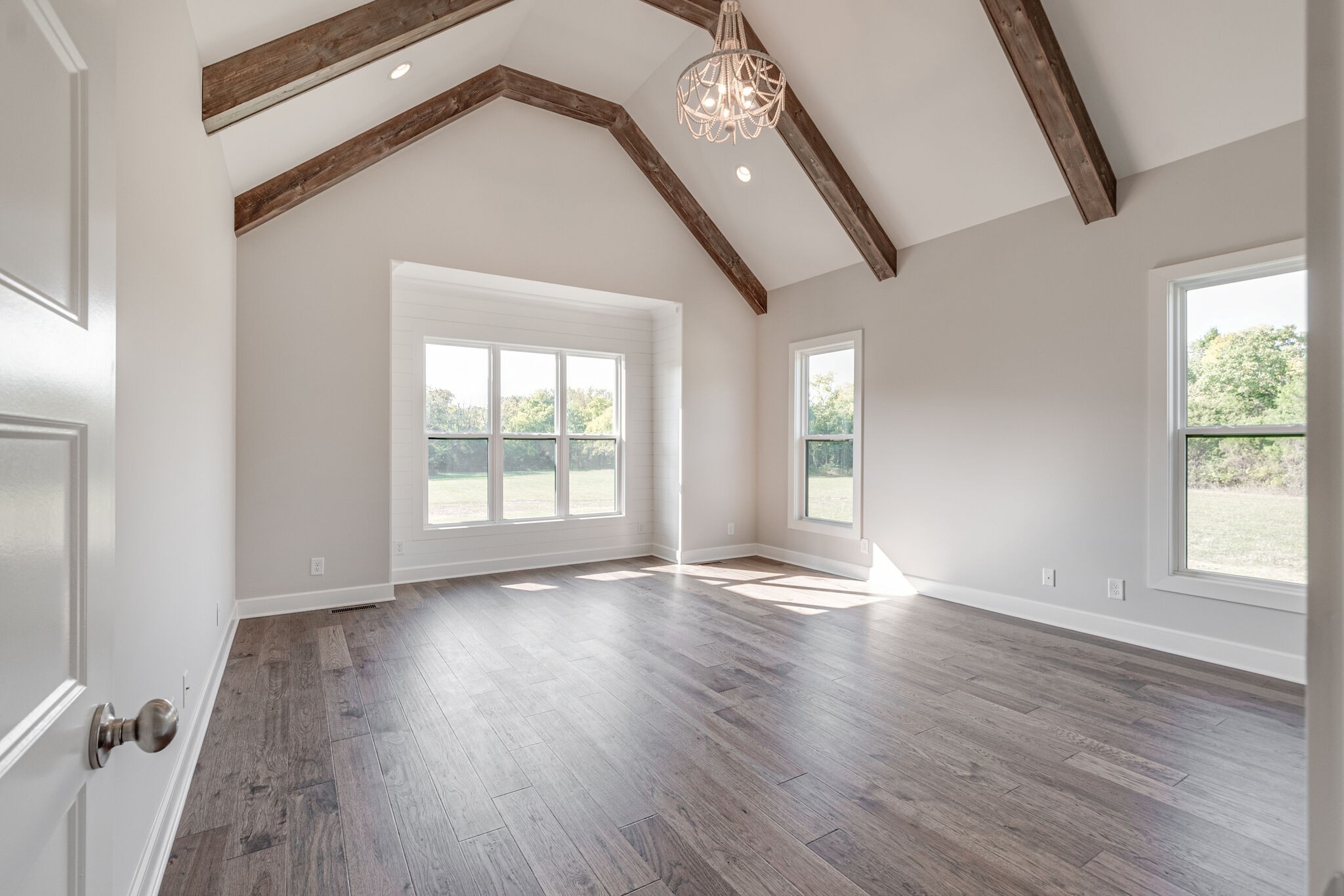 12599 North Milton Road Milton, TN 37118 - Photo 19 of 34 an empty room with wooden floor and windows
