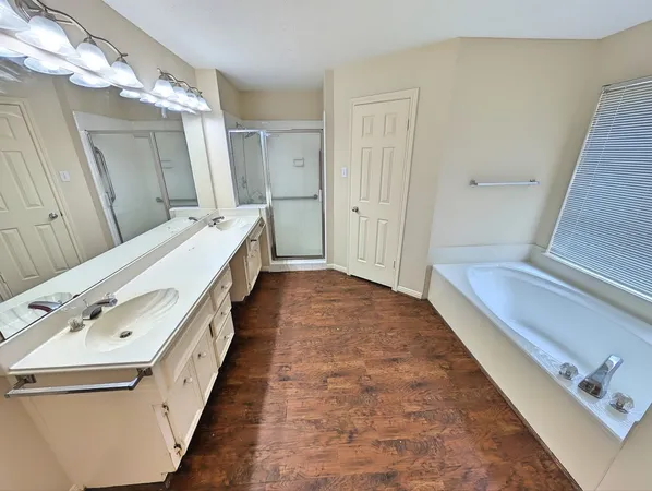 a bathroom with a double vanity sink and mirror