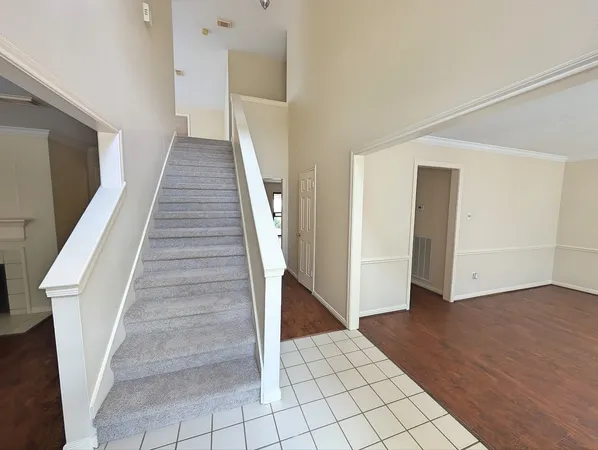 a view of an entryway with wooden floor