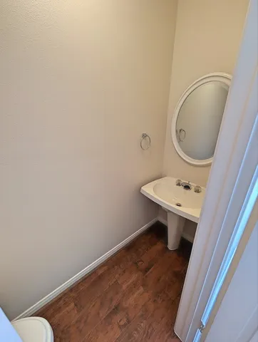 a bathroom with a sink a toilet and mirror