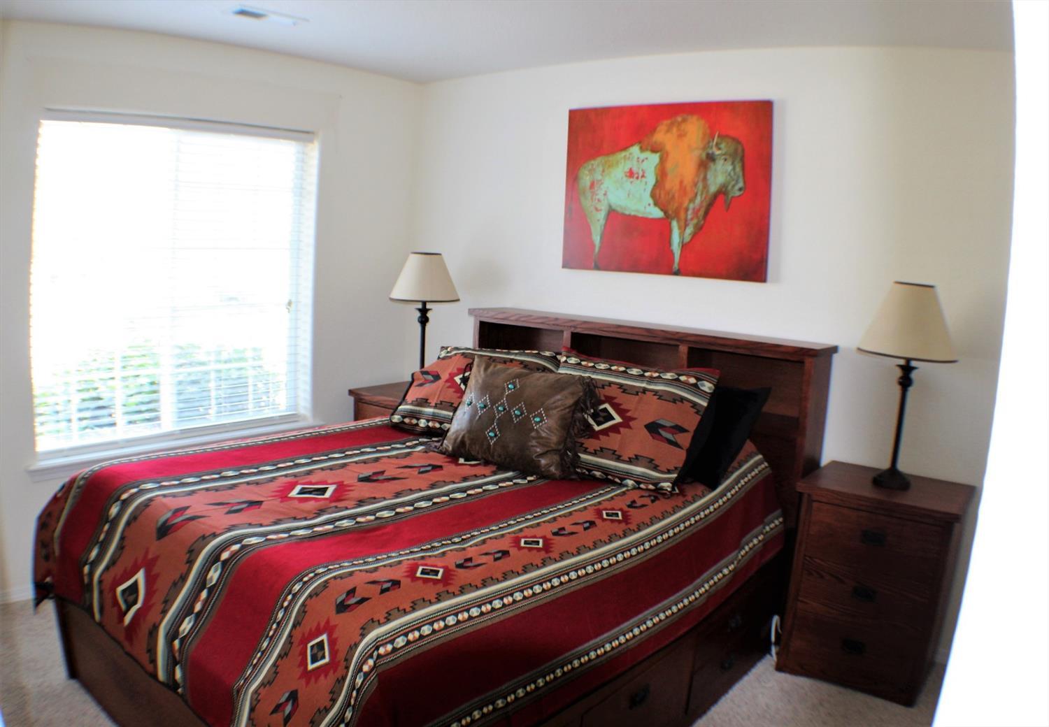 1246 Poppy Ridge Drive Eagle Point, OR 97524 - Photo 20 of 34 a bed sitting in a bedroom next to a window