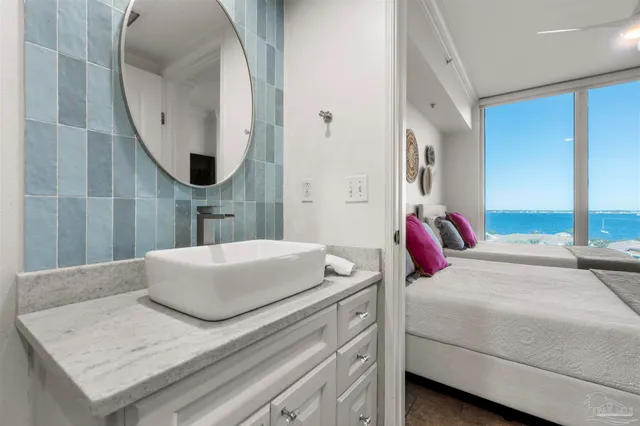 a bedroom with a large bed and a mirror