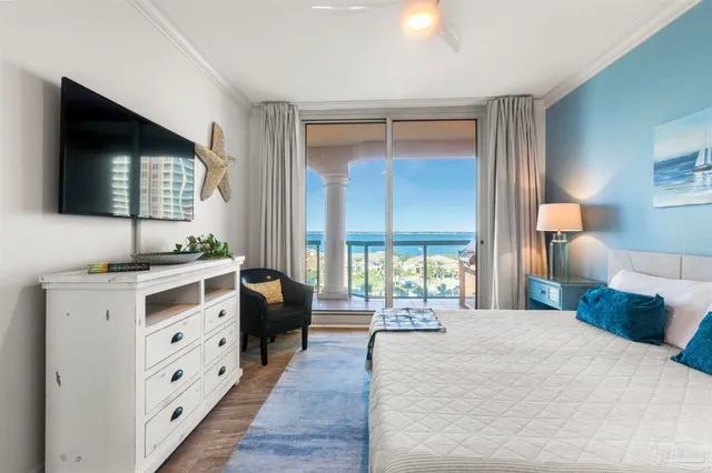 a spacious bedroom with a large bed and a flat tv screen on dresser