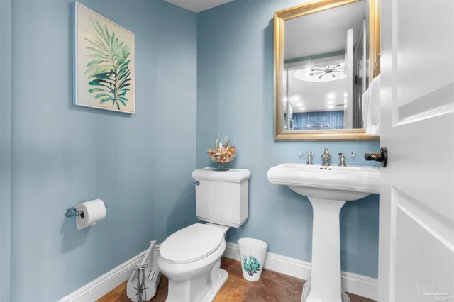 a bathroom with a sink mirror and toilet