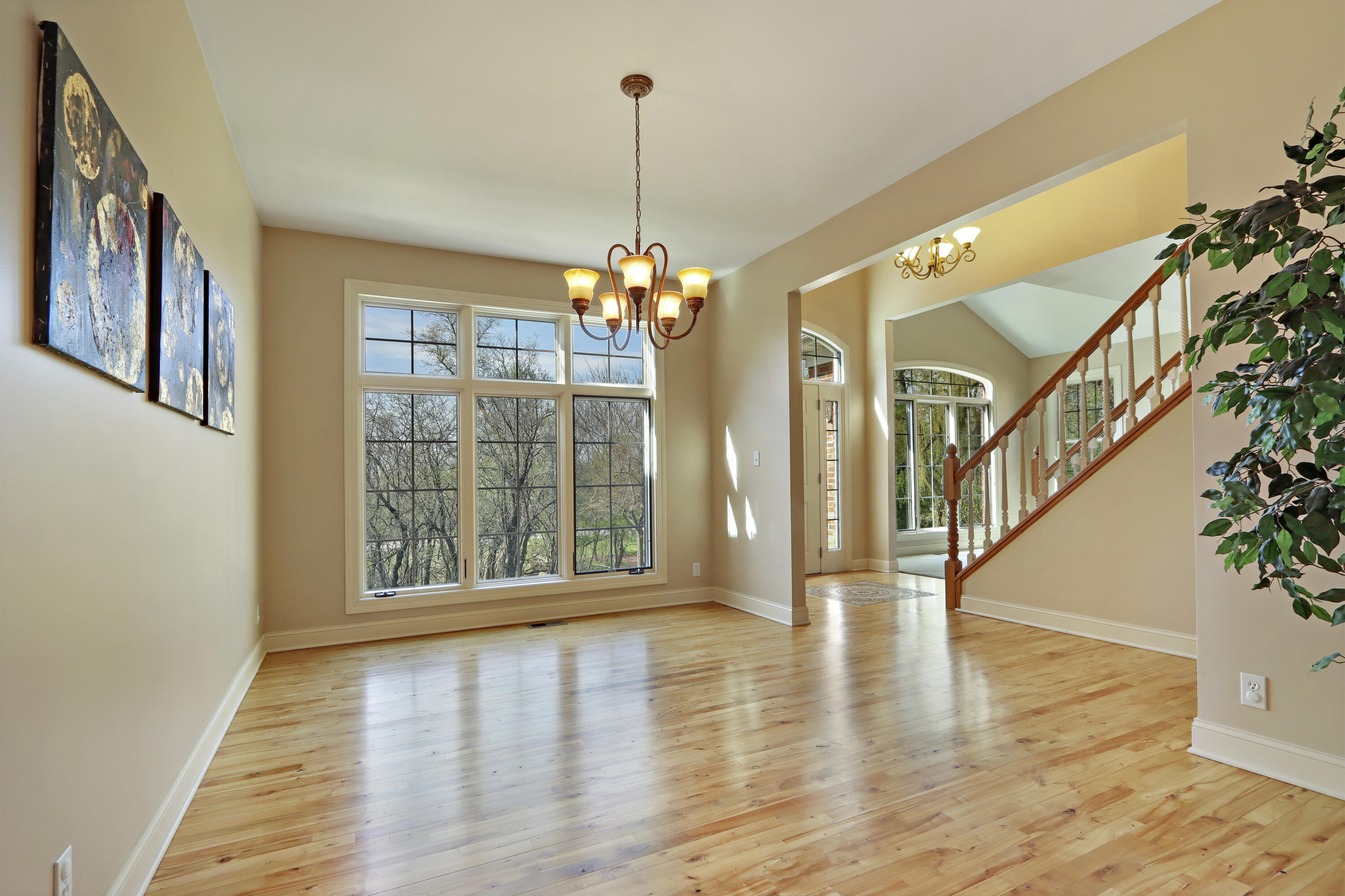 392 County Road B Fontana, WI 53125 - Photo 9 of 75 The Formal Dining Room has transom-topped windows, wood floors and is open to the entry, Formal Living Room, Great Room and Kitchen