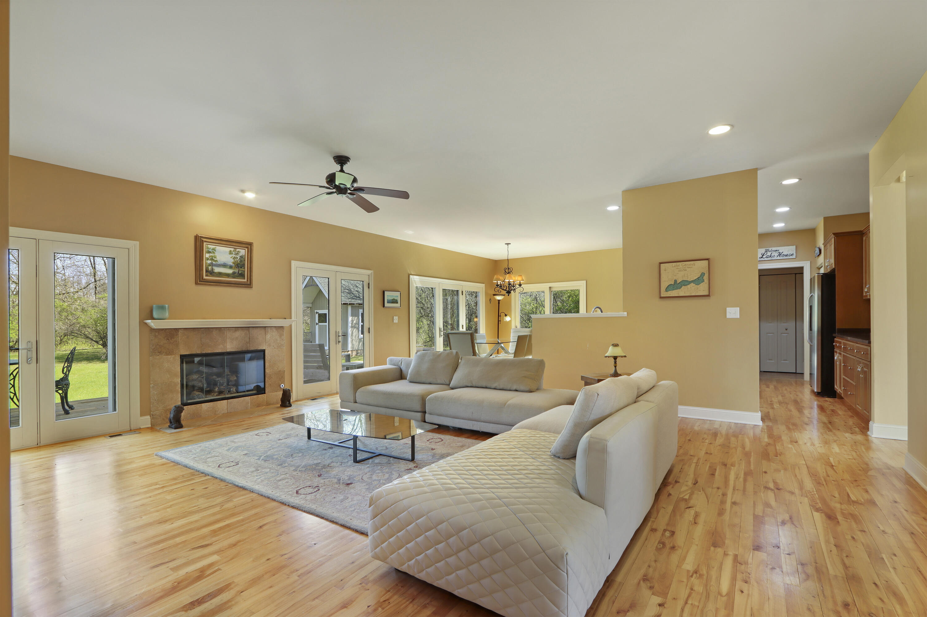 392 County Road B Fontana, WI 53125 - Photo 12 of 75 Curl up by the Great Room Gas Fireplace with flush hearth, tile surround and wood mantle or gather for lively conversations in the heart of this home.