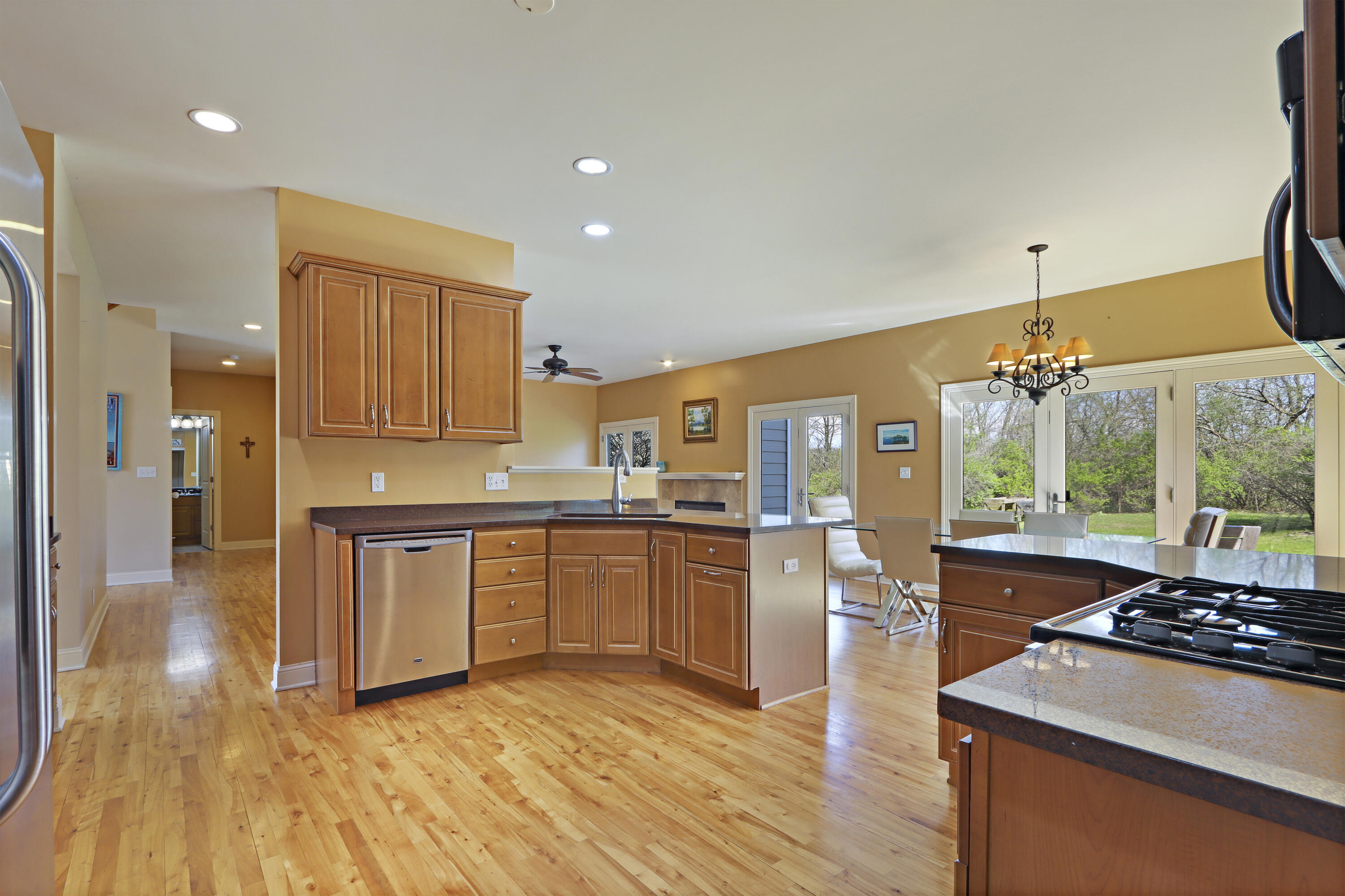 392 County Road B Fontana, WI 53125 - Photo 19 of 75 This spacious kitchen has room to cook and entertain a crowd and has wood floors and pecan hued cabinets