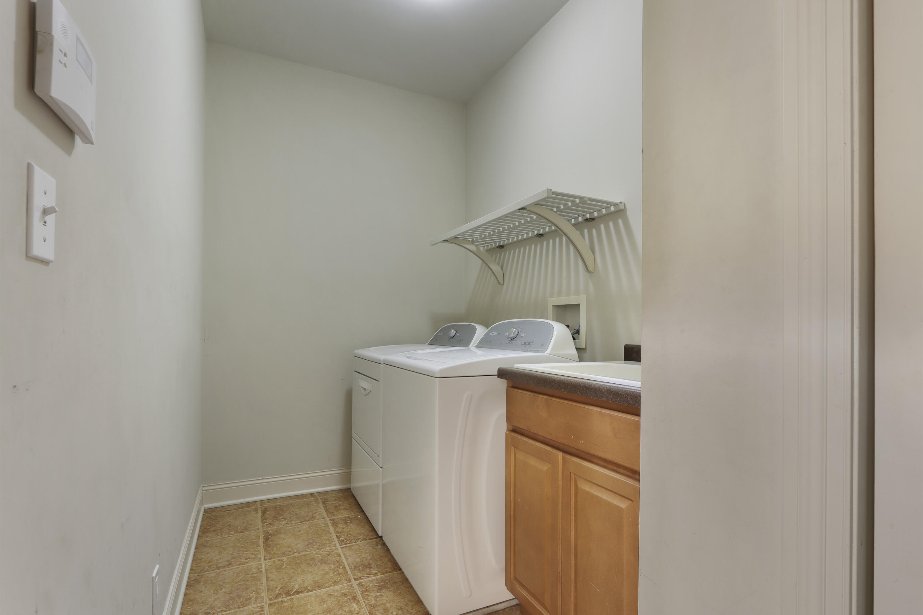 392 County Road B Fontana, WI 53125 - Photo 20 of 75 The ML laundry room is located just off the rear entry and kitchen and has tile floors, a utility sink cabinet and coat/cleaning closet