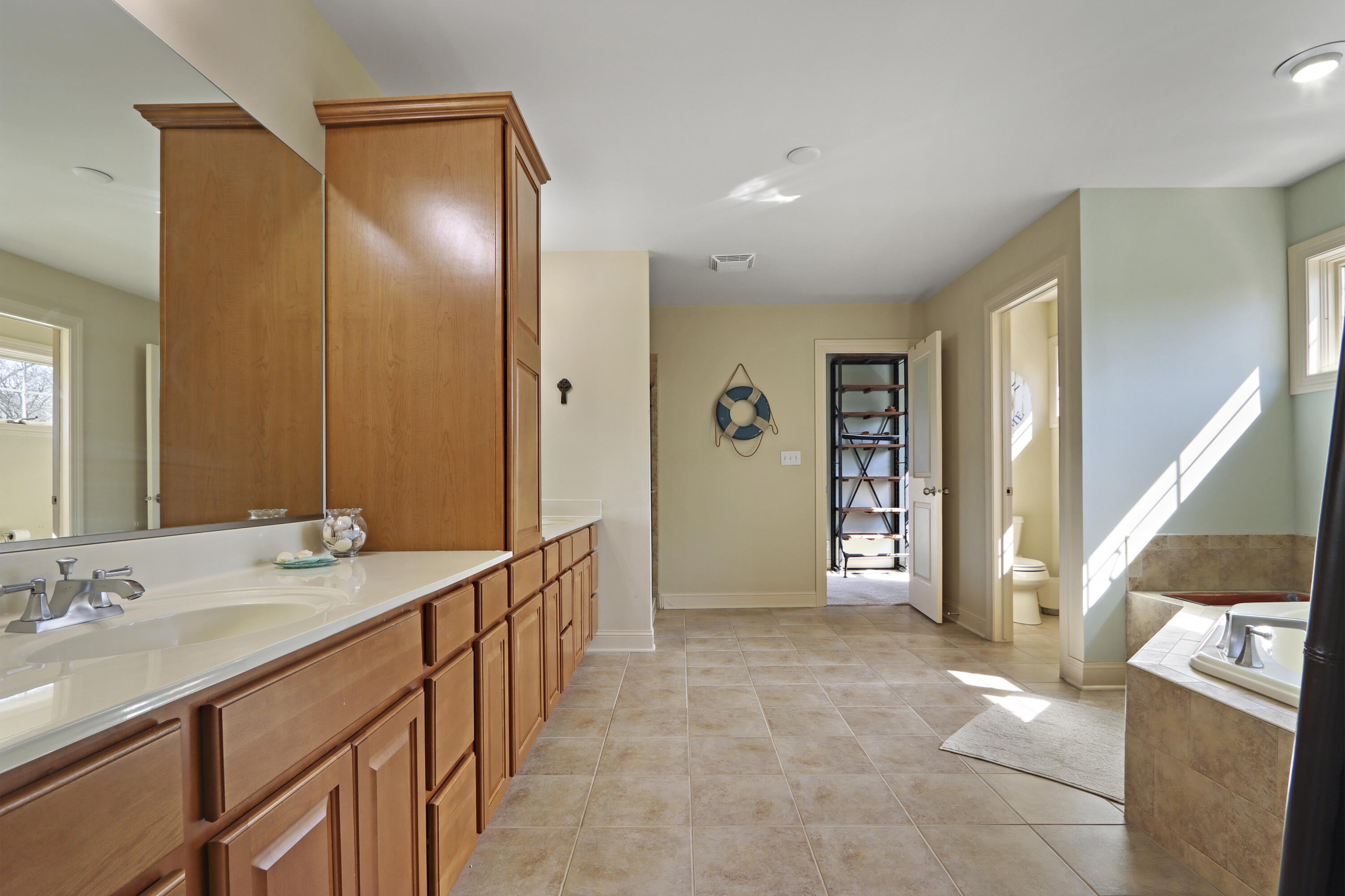 392 County Road B Fontana, WI 53125 - Photo 30 of 75 The Primary Suite Bathroom opens from the Primary Bedroom and is filled with natural light