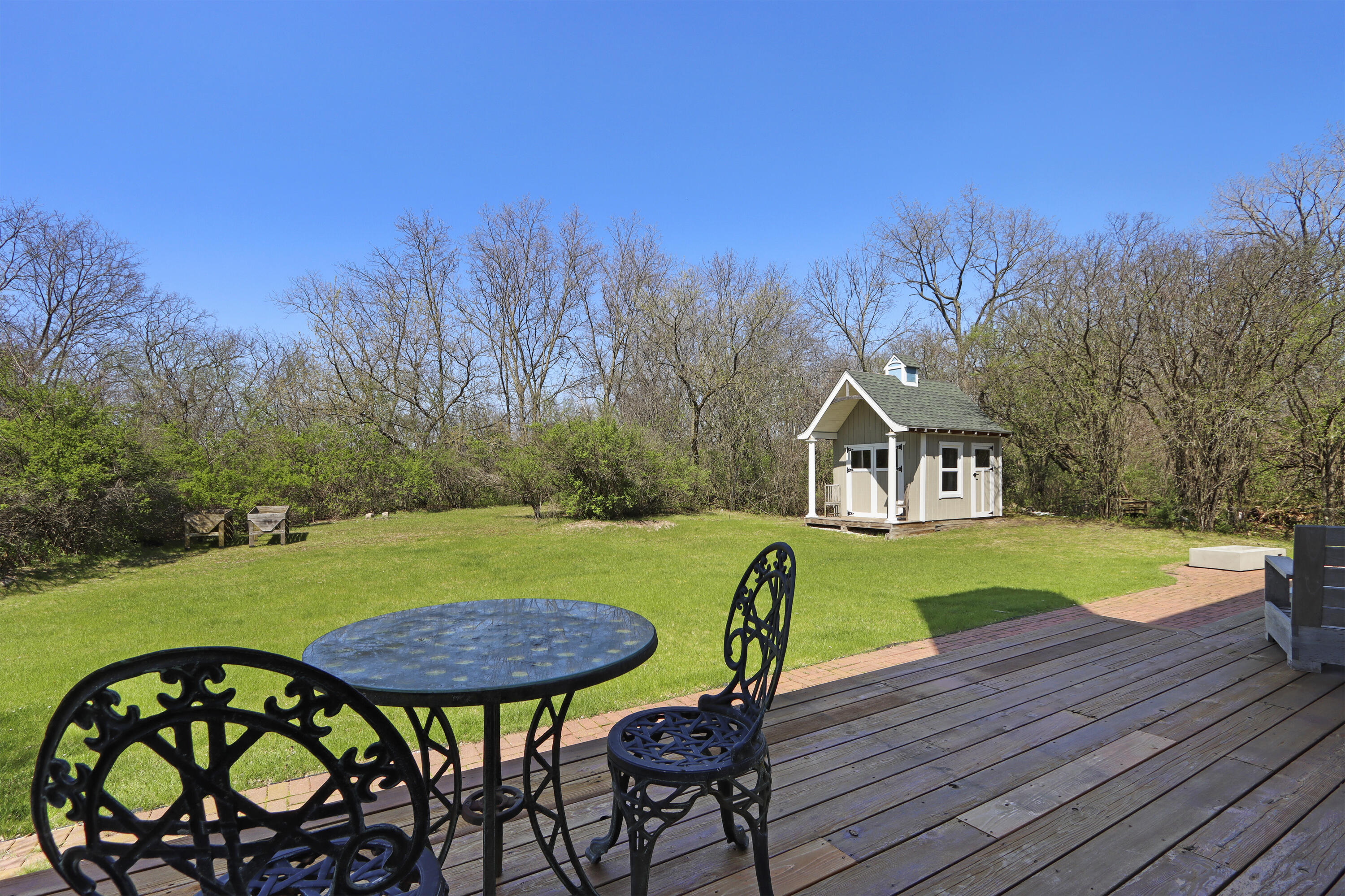 392 County Road B Fontana, WI 53125 - Photo 46 of 75 The wrap-around deck is the perfect place to enjoy the birds and wildlife and the views towards the conservancy with walking trails and golf course