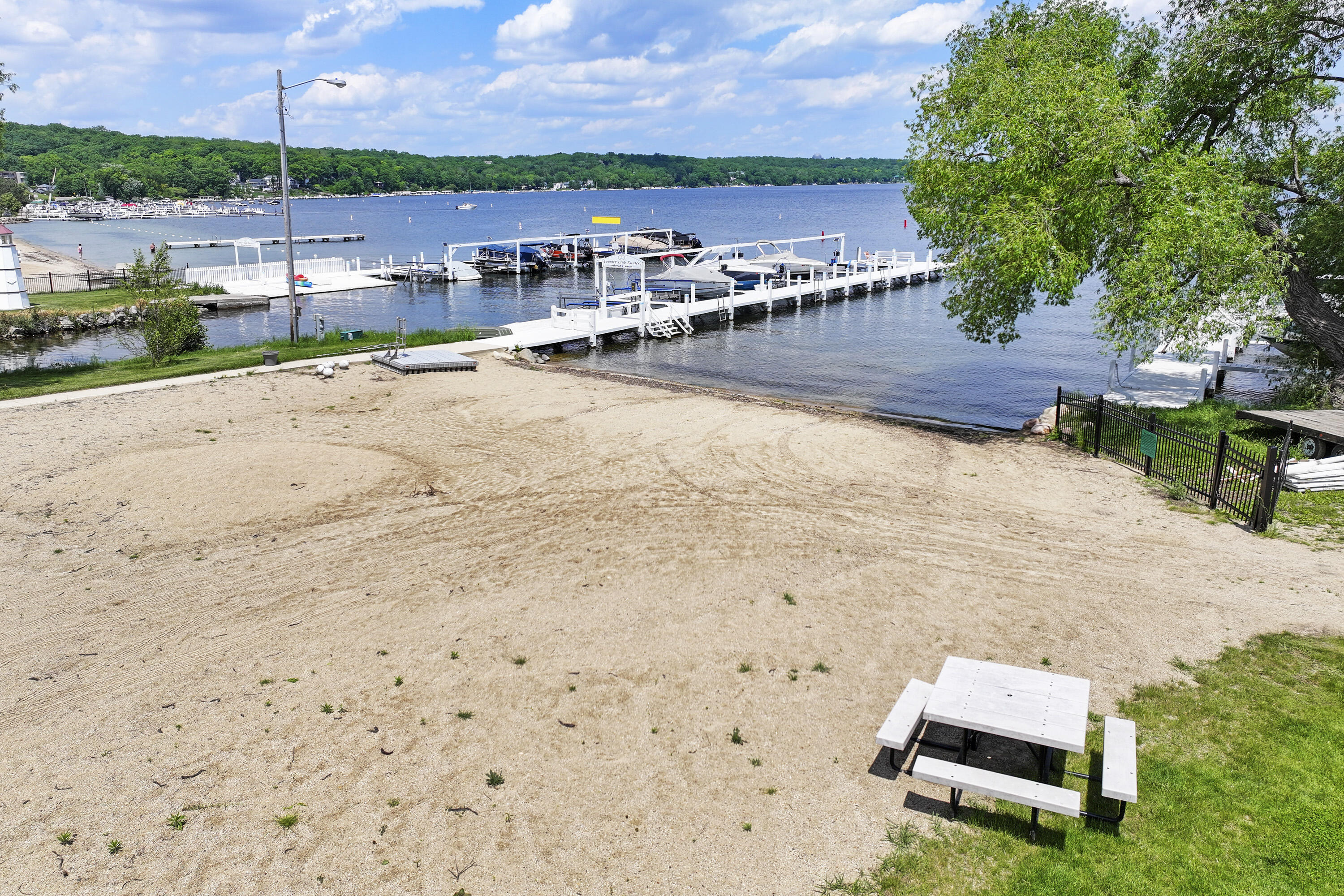 392 County Road B Fontana, WI 53125 - Photo 3 of 75 The sandy Country Club Estates beach is a great gathering place for neighbors to enjoy the lake and one another