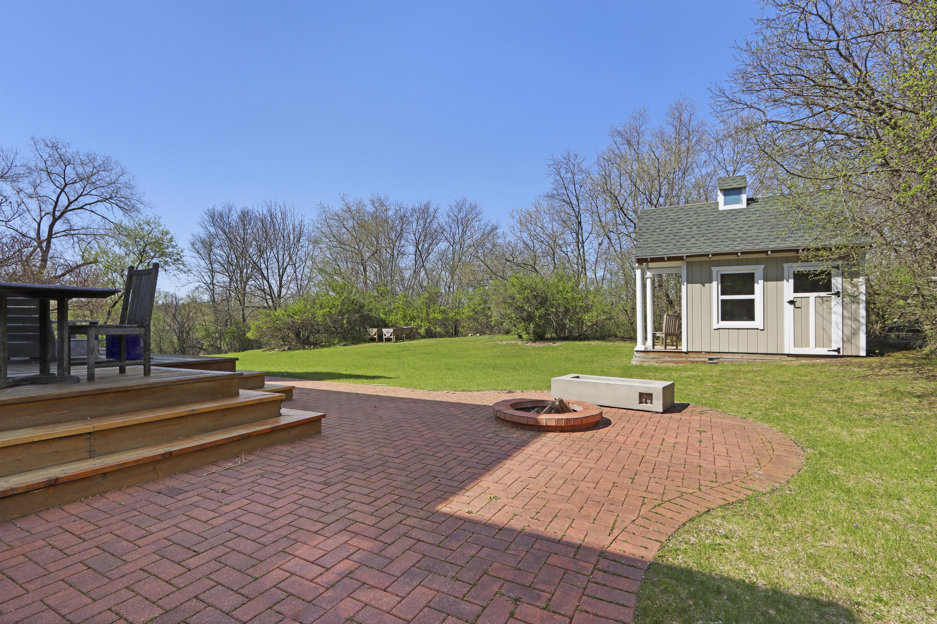 392 County Road B Fontana, WI 53125 - Photo 48 of 75 The large, wrap-around brick paver patio has a fire pit that is perfect for S'Mores or taking the chill out of the evening air