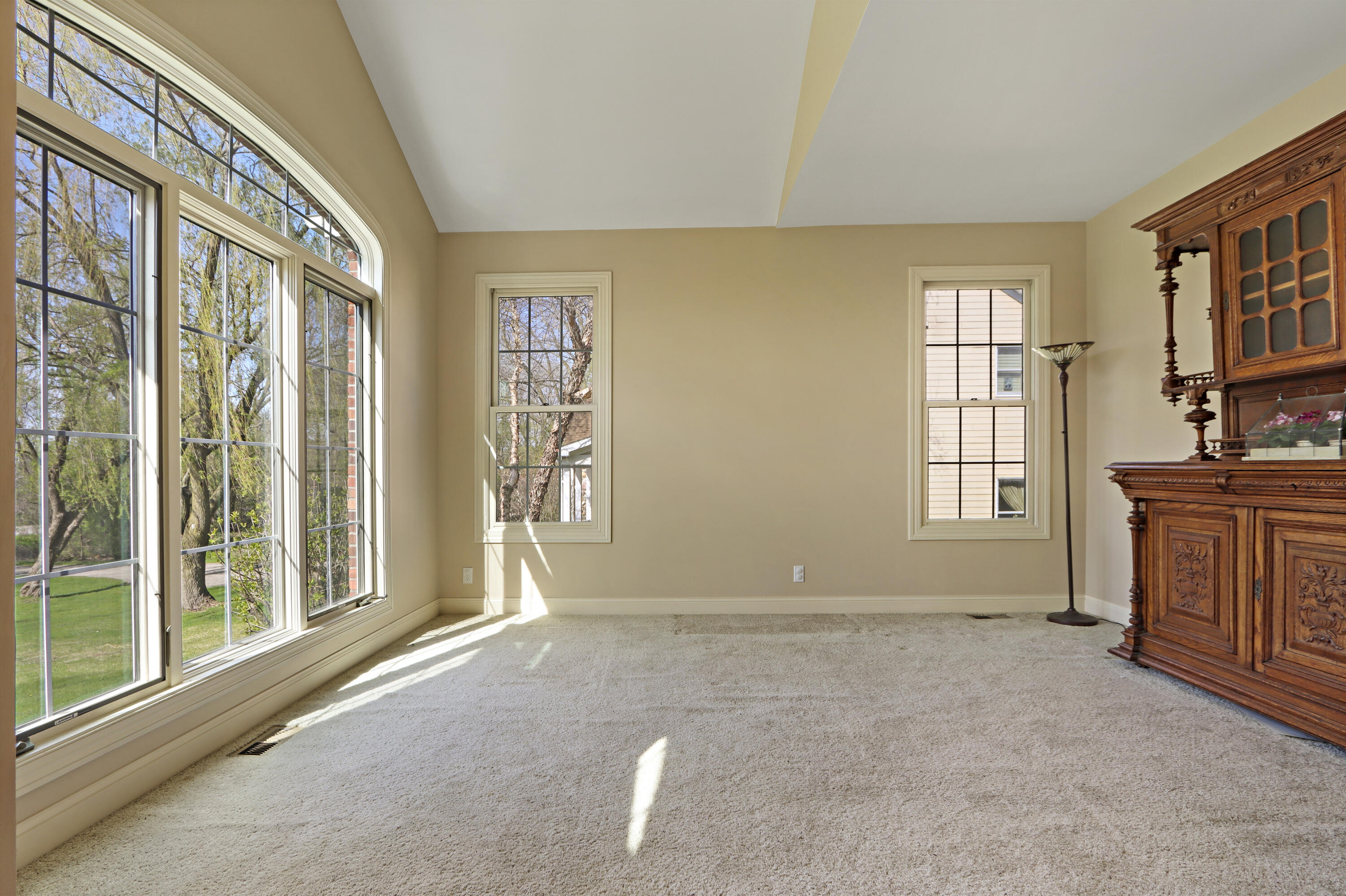 392 County Road B Fontana, WI 53125 - Photo 7 of 75 The Formal Living Room has a pretty arched transom-topped oversized window overlooking the front yard