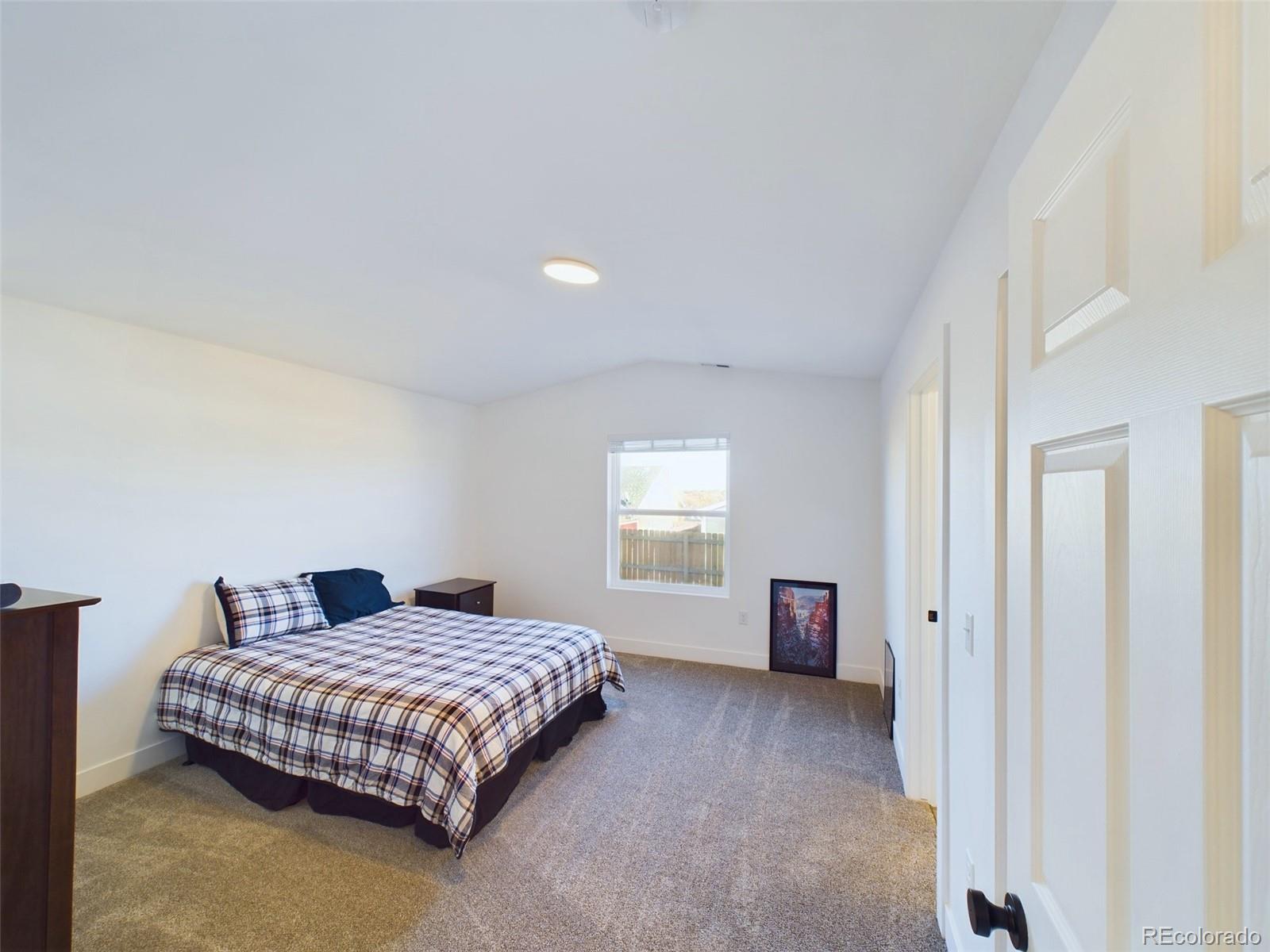 1439 Brewery Road Pueblo, CO 81001 - Photo 11 of 25 a bedroom with a large bed and a couch