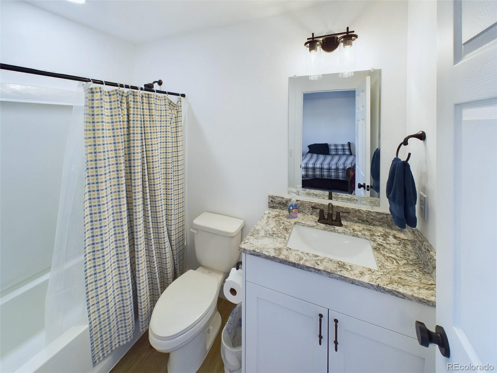 1439 Brewery Road Pueblo, CO 81001 - Photo 13 of 25 a bathroom with a granite countertop sink toilet and shower