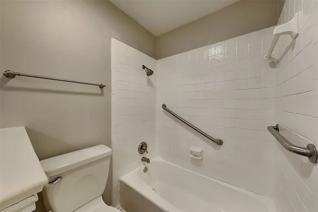 a bathroom with a bathtub and a toilet